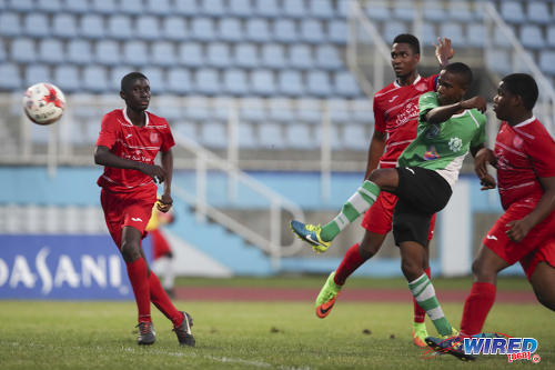 Photo: Carapichaima East attacker Theophilus Bourne (centre) shoots for goal during Intercol Central Zone semifinal action against Presentation (Chaguanas) at the Ato Boldon Stadium on 15 November 2017. (Courtesy Allan V Crane/CA-Images/Wired868)