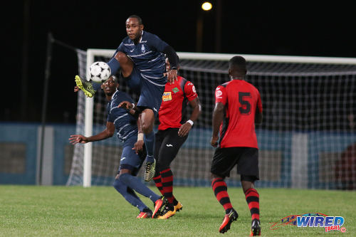 Photo: Police FC midfielder Christon Thomas (airborne) controls the ball during Pro League against San Juan Jabloteh at the Ato Boldon Stadium on 1 November 2016. Jabloteh won 3-2. (Courtesy Chevaughn Christopher/Wired868)