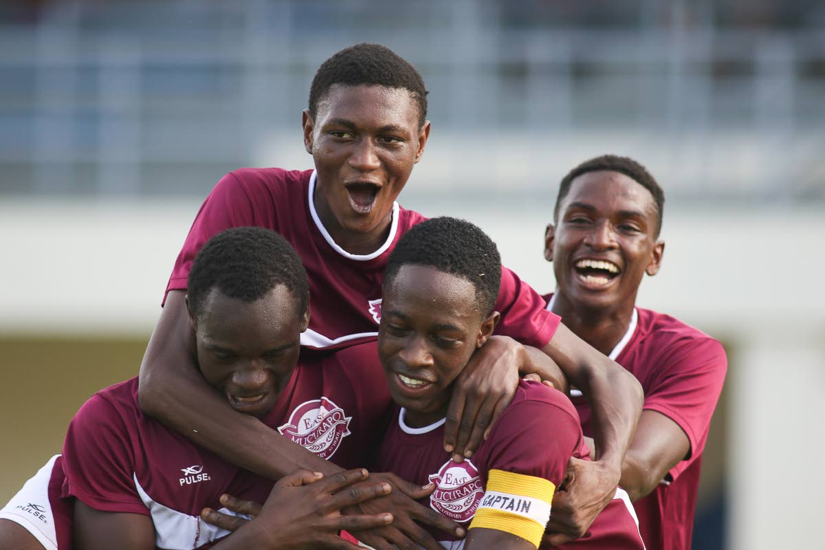 PROMOTED! East Mucurapo Secondary captain Kevon Edwards, second from left, celebrates with his teammates following their victory over Valencia Secondary during SSFL Championship division action last Sunday. East Mucurapo was promoted to the Premier Division following their win over Chaguanas North Secondary, yesterday. Photo by:Chevaughn Christopher/CA-images.