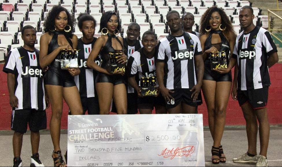 CHAMPS: Real Madrid FC’s team leader Kareem Creighton, centre, and Anthony Thompson, fourth from right, pose with their teammates and Guinness promotional representatives after emerging victorious at the 2016 Guinness Street Football Challenge’s Northern Division playoffs at the Jean Pierre Complex, Port of Spain, on Saturday. 