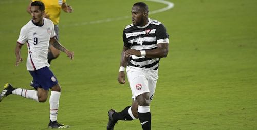 Photo: Trinidad and Tobago defender Josiah Trimmingham (right) tries to keep a lid on USA forward Jesus Ferreira during international friendly action in Orlando on 31 January 2021. Ferreira scored twice and created two other goals in a 7-0 rout..... (Copyright AP Photo/Phelan M Ebenhack)