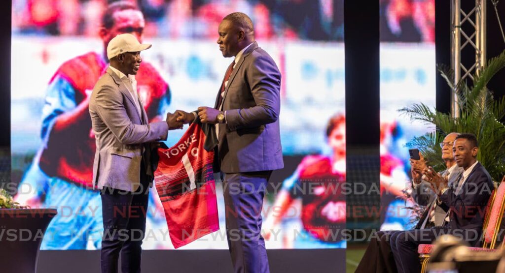 In this November 14 file photo, TT Football Association president Kieron Edwards, right, presents TT legend Dwight Yorke with a jersey during the latter’s unveiling as the new senior men’s head coach, during a ceremony at the Ato Boldon Stadium, Couva. - Photo by Jeff K Mayers