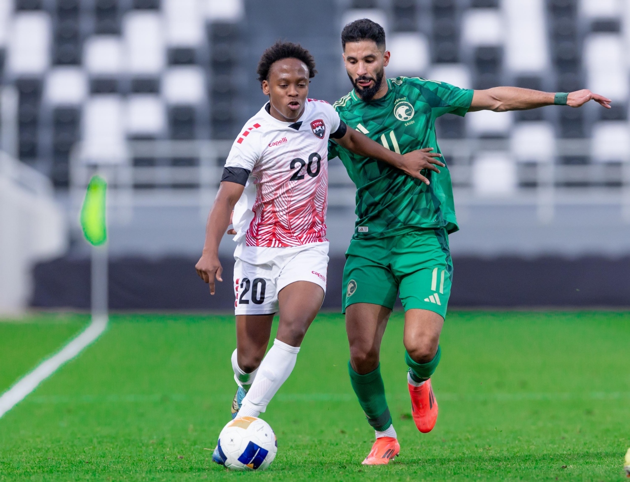 Trinidad and Tobago attacker Real Gill (left) tries to keep the ball from a Saudi Arabia opponent during an international friendly in Riyadh on 17 December 2024. (via TTFA Media)