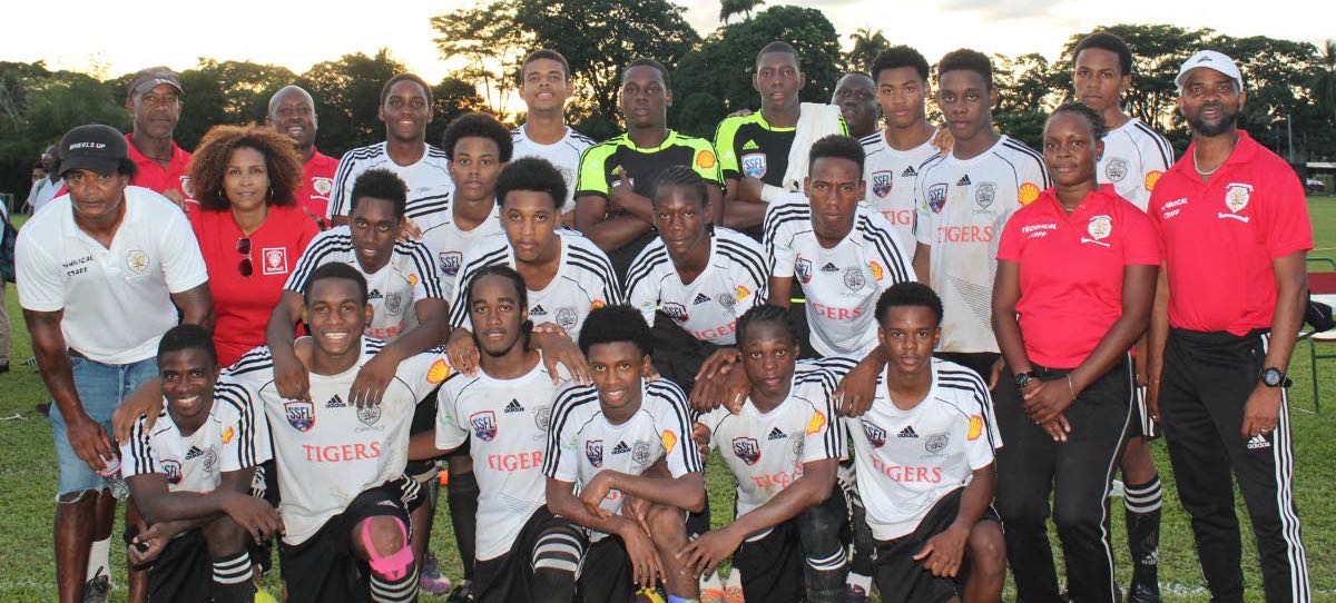 St Anthony’s College players, coach and management team pose after booking their spot in the Coca Cola North Intercol final yesterday.