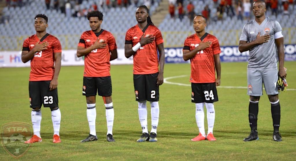 Aubrey David (Centre) alongside Jesse Williams (extreme left), Triston Hodge, Kevon Goddard(#24) and Marvin Phillip during the national anthem against Guyana.(TTFA Media)