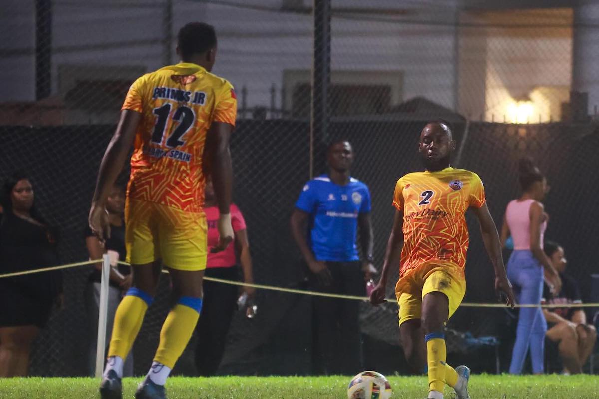 AC Port of Spain's Brandon Semper (right) passes the ball to teammate Robert Primus (left) during a TTPFL game against Caledonia AIA at the Ken Cooke Ground, Police Barracks, St. James on Sunday, December 22nd 2024.