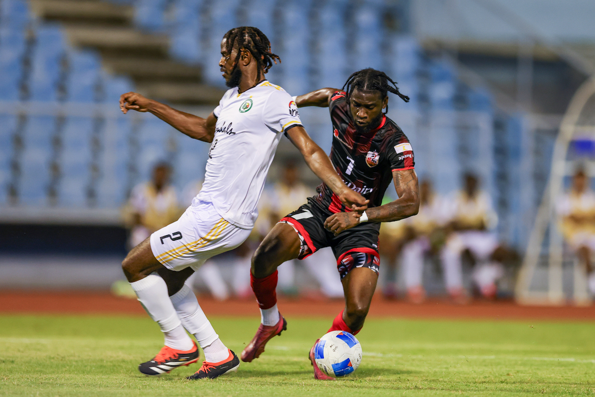 AC Port of Spain’s Sedale McClean (right) battles for the ball with Grenades FC's Kurt Frederick (left) during a Concacaf Caribbean Cup match at Hasely Crawford Stadium, Mucurapo on Tuesday, September 17th 2024.