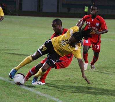 T&TEC striker Bevon Bass, centre, chases after the ball between the Neal & Massy Caledonia AIA duo of Nuru Abdullah Muhammad, left, and Radanfah Abu Bakr during their Lucozade Sport Goal Shield semifinal at the Mannie Ramjohn Stadium, Marabella on Friday night. Caledonia won 3-1. Photo: Rishi Ragoonath.