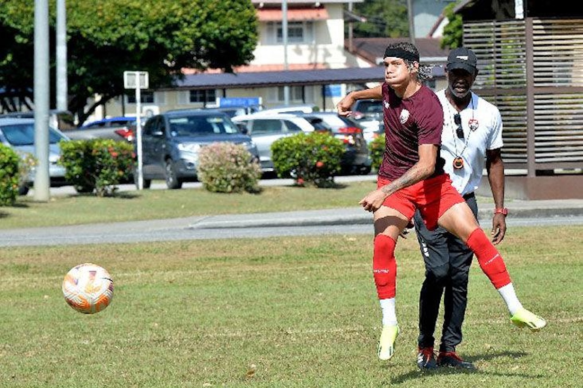 England-born Crystal Palace and Trinidad and Tobago midfielder Rio Cardines gets in some work at The University of the West Indies yesterday during the final training session before T&T begin their CONCACAF U2-0 Group D qualifying series against St Vincent and the Grenadines tonight at the Hasely Crawford Stadium, Port of Spain, from 7 o’clock. Also in photo is assistant coach Gilbert Bateau. PHOTO BY: Robert Taylor