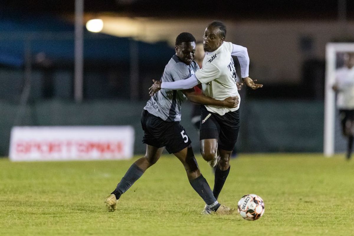 La Horquetta Rangers' Tyrone Charles, right, gets past the challenge from Police FC Keshawn Hutchinson (No.5) during the Ascension Tournament at the Phase 2 Recreation Grounds on April 1st 2022 in La Horquetta.