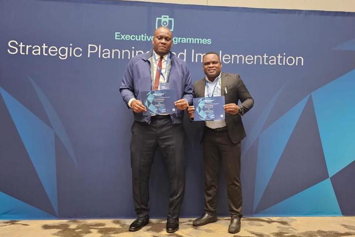 TTFA President Kieron Edwards with President of the St Vincent and the Grenadines Football Federation Otashie Spring, with their certificates on display at the end of the Executive Programme.