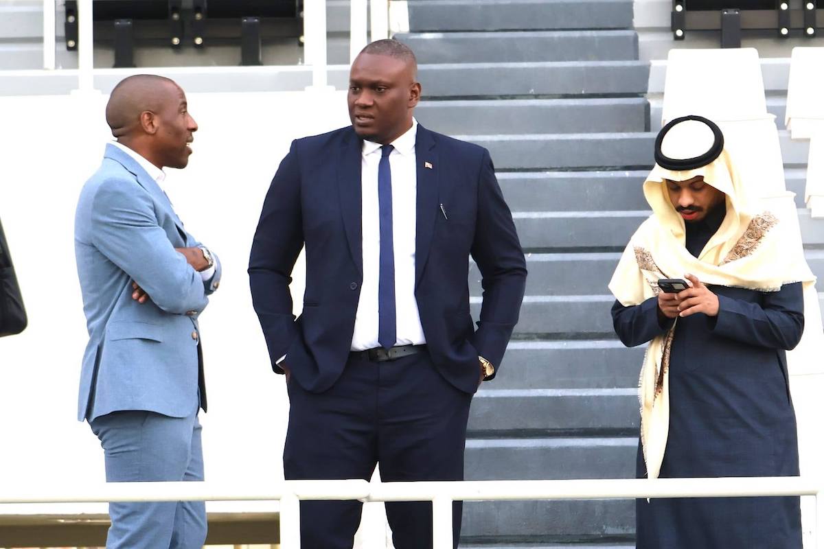 TTFA President Kieron Edwards (center) speaks with Saudi Arabian Football Federation International Media Officer Frédéric Nkeuna (left) during the International Friendly between Saudi Arabia and Trinidad and Tobago at Al-Shabab Club Stadium, Riyadh, Saudi Arabia on Tuesday, December 17th 2024.