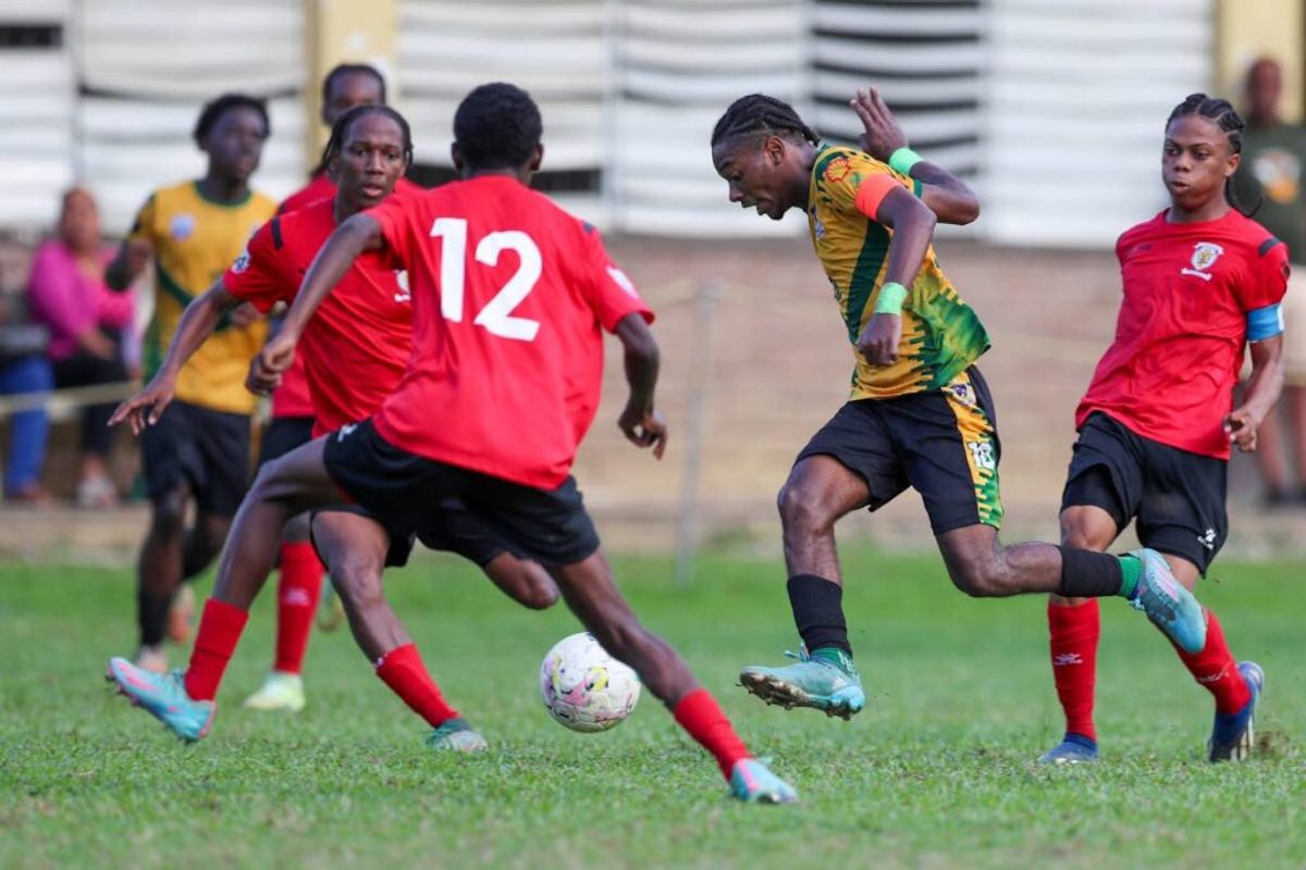 St Benedict's College's Derrel Garcia, centre, tries to weave his way through the St Anthony's defence during an SSFL Premiership match at the St Anthony's College Ground on October 7th 2024, in Westmoorings. PHOTO BY Daniel Prentice