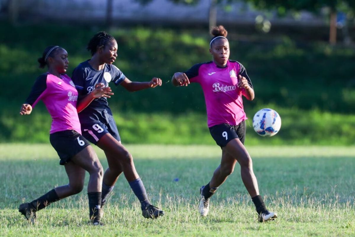 Pleasantville Secondary's Nikita Gosine, right, and Natalia Gosine, left, close down the attack from Miracle Ministries' Kyanna Isaac during the SSFL Intercol Girls semifinal at the Lewis Street grounds on Sunday, December 1st 2024, in San Fernando. PHOTO BY Daniel Prentice