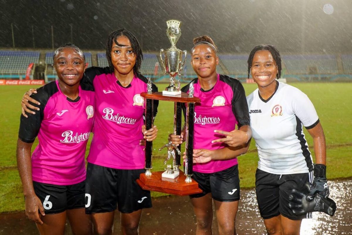 From left, Pleasantville Secondary School's Natalia Gosine, Tayeann Wylie, Nikita Gosine and goalkeeper Janike Ramoutar with the winners trophy after defeating Five Rivers Secondary in the SSFL Girls Big 5 final at the Ato Boldon Stadium on Tuesday, November 26th 2024 in Balmain, Couva. PHOTO BY Daniel Prentice