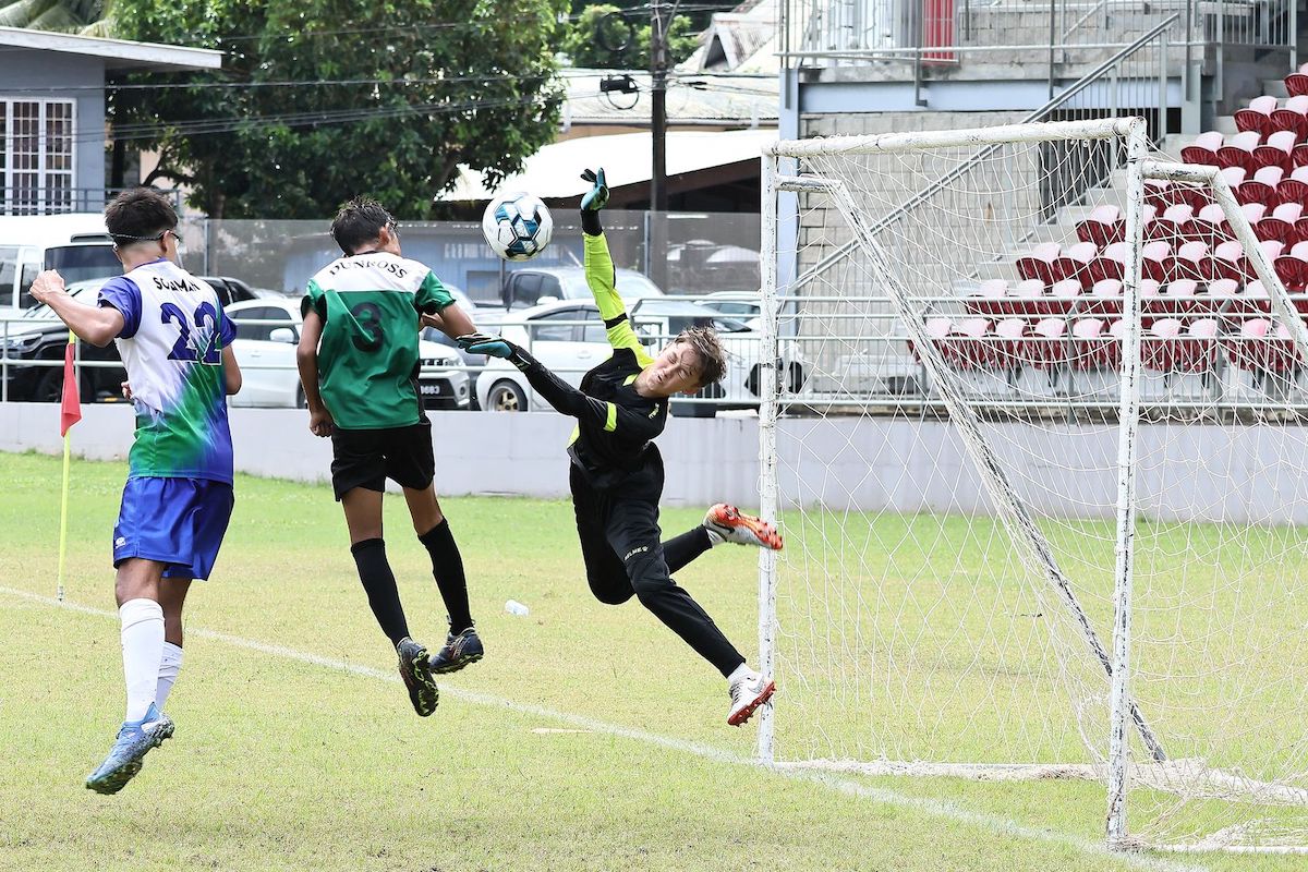 Dunross Prepartory School's custodian Maddox Selby attempts to save a header from International School of Port of Spain's Jose Soliman (No 22) during the POS & Environs Primary Schools Football League finals at the Diego Martin Sporting Complex, Ken Valley Road, Diego Martin on Wednesday, November 6th 2024. ISPS won 6-1. PHOTO BY Abraham Diaz