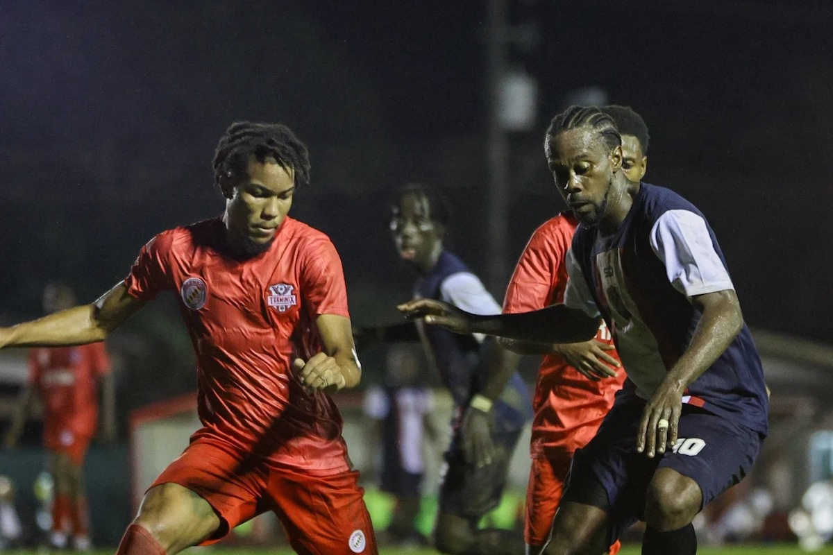 Caledonia's Marcus Joseph (right) tries to elude a couple of La Horquetta Rangers players during a TTPFL match at La Horquetta Recreation Ground on Friday, December 6th 2024.