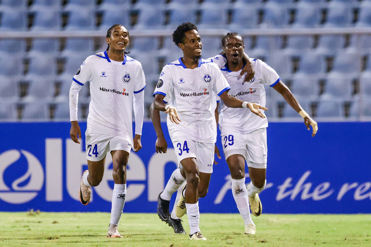 Police FC's Ezekiel Kesar (#34) celebrates with teammates Josiah Wilson (#24) and Kadeem Hutchinson (#29) after scoring the winning goal in a 2-1 victory over Arnett Gardens FC in a Concacaf Caribbean Cup match at the Hasely Crawford Stadium, Mucurapo on Thursday, September 19th 2024.