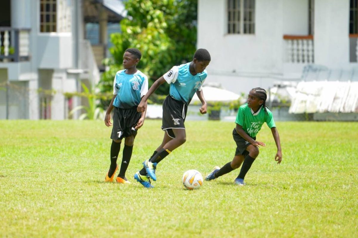 A Lambeau Anglican player, centre, takes on a Patience Hill Government player, right, during Tobago Primary Schools' Football League action at Signal Hill Recreation Ground on Monday, October 7th 2024. PHOTO BY Maurice Goddard