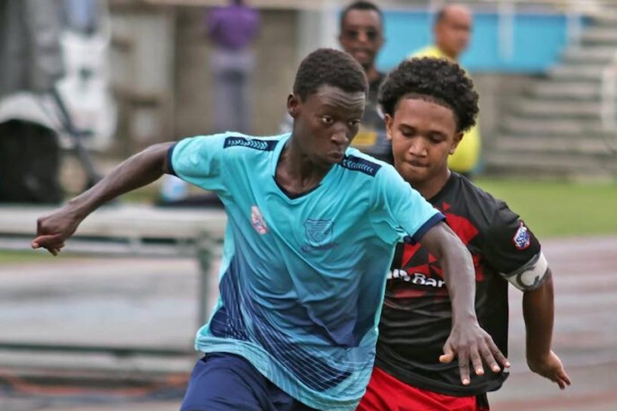 Miracle Ministries Pentecostal High School’s Daniel Blacks is chased by Presentation College Chaguanas captain Josh Koo in the Coca-Cola Central Zone semifinals at the Ato Boldon Stadium, on Tuesday, November 11th, 2024. PHOTO BY Lincoln Holder