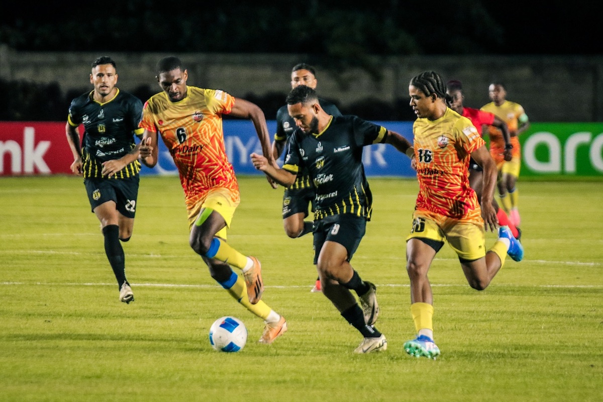 C Port of Spain’s Weslie John (#6) and Liam Burns (#16) challenge Moca FC's Juan Ángeles (#8) for the ball, during their 2024 CONCACAF Caribbean Cup, Group B clas at Estadio Moca 85, Moca, Dominican Republic on Tuesday, August 27th 2024.