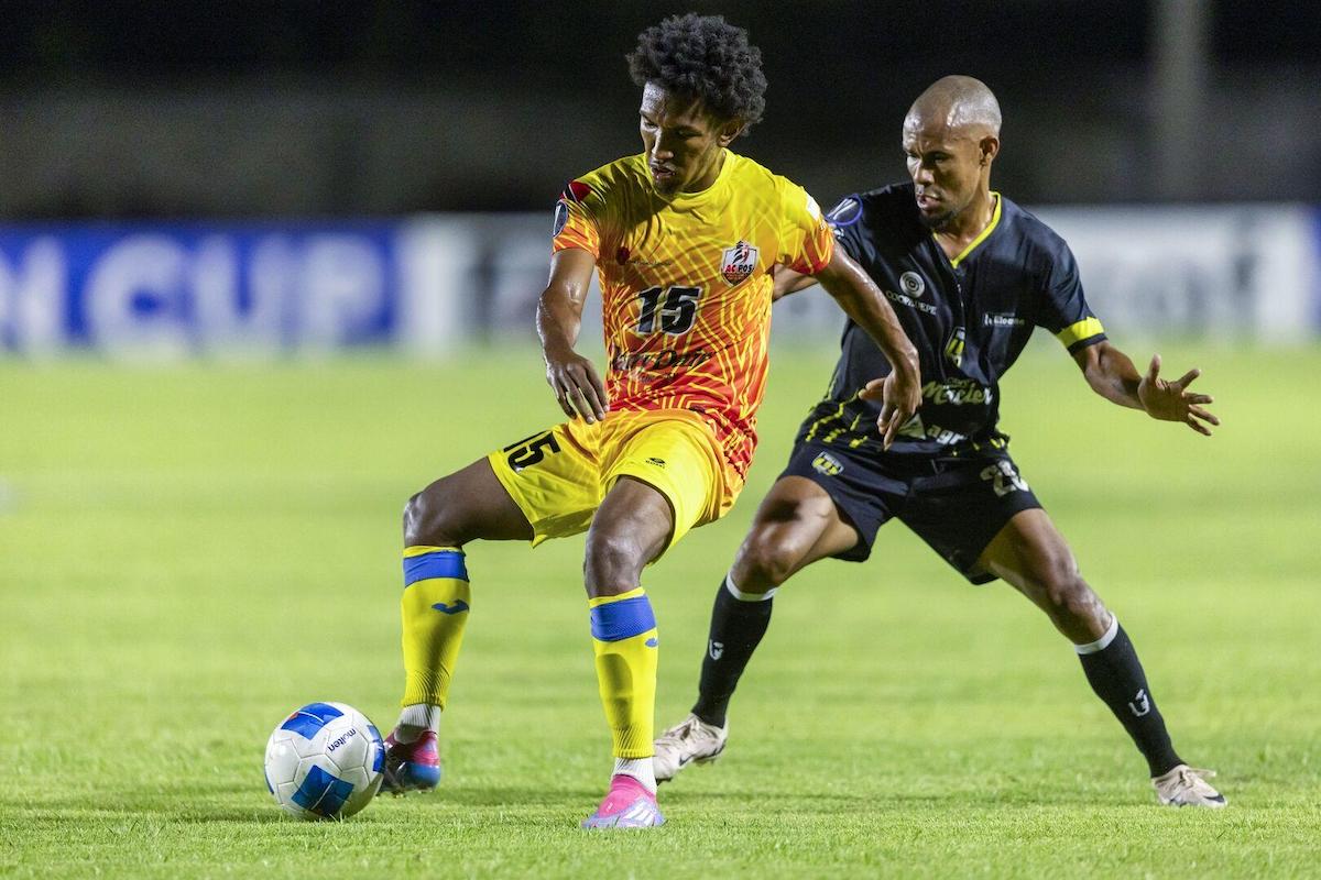 AC Port of Spain’s John-Paul Rochford, left, fends off Moca FC defender Guillermo De Peña, during their 2024 CONCACAF Caribbean Cup, Group B clas at Estadio Moca 85, Moca, Dominican Republic on Tuesday, August 27th 2024.. PHOTO: Nelson Pulido/Concacaf