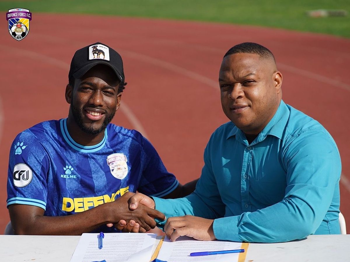 New Defence Force signing Kevin Molino, left, and Defence Force club director, Flight Lieutenant Ryan Ottley.