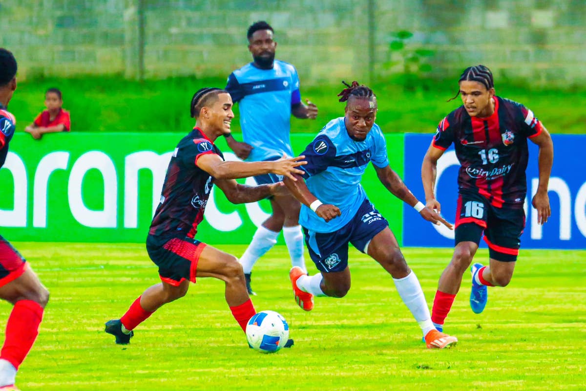 AC Port of Spain's Michel Poon-Angeron (left) and Liam Burns (right) try to stop Ouanaminthe's Joseph Willinx (center) during a Concacaf Caribbean Cup match at Estadio Moca 85 Stadium, Moca, Dominican Republic on Thursday, August 22nd 2024.