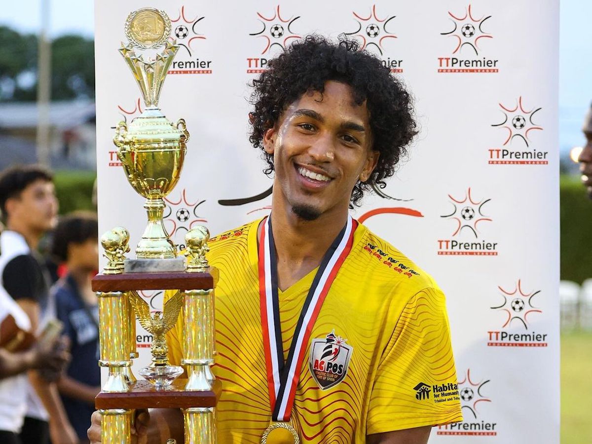 AC Port of Spain's Michel Poon-Angeron pose with the 2023/24 TTPFL trophy after defeating Point Fortin Civic FC 3-0 at Mahican Oval, Point Fortin on May 19th 2024.