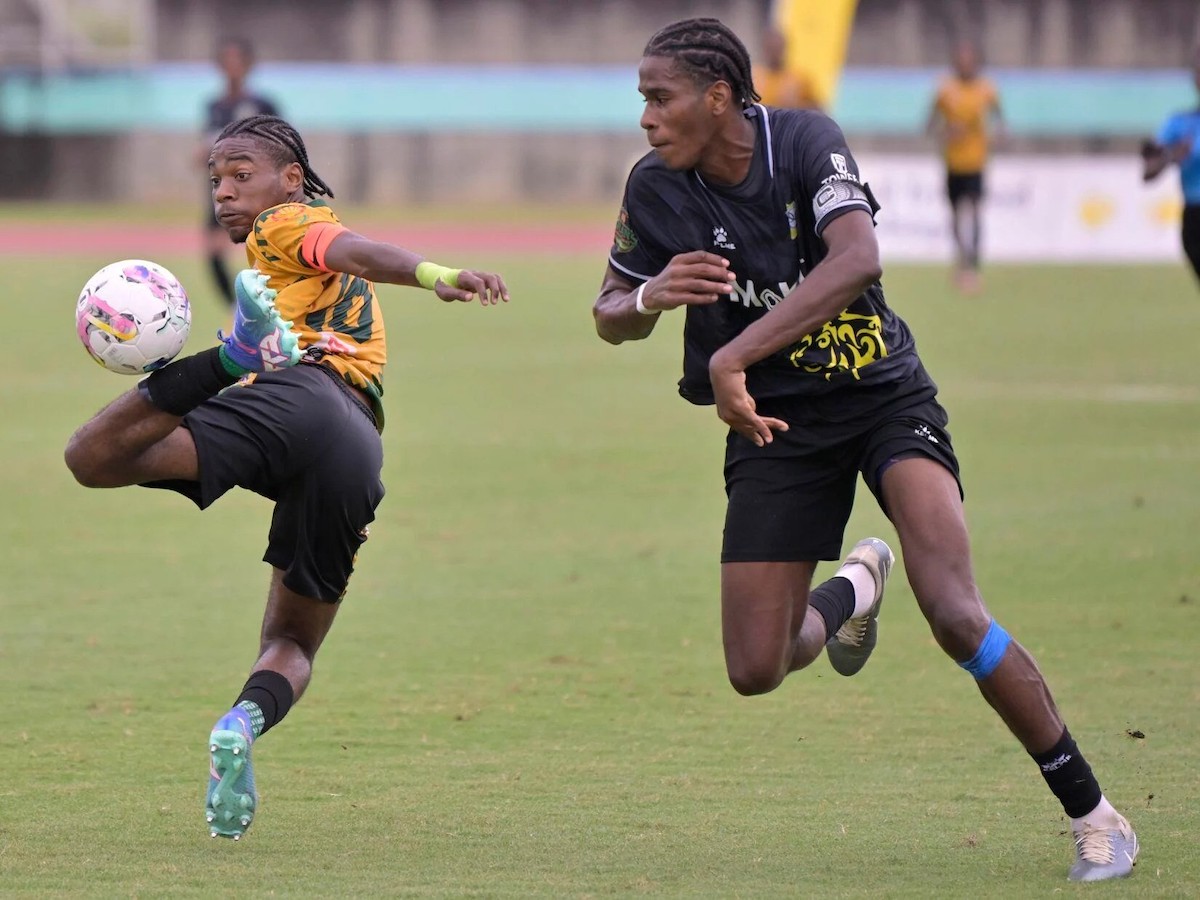 Presentation College (San Fernando) captain Cody Cooper, right, closes in on St Benedict’s College’s star striker Derrel “Zoom Zoom” Garcia, during an SSFL Premier Division top-of-the-table clash, at the Manny Ramjohn Stadium, Marabella on Wednesday, October 23rd 2024. PHOTO BY Dexter Phillip