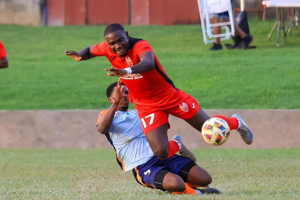 1976 FC Phoenix's Che Richards (#17) is tackled by a Prison Service FC player during their TTPFL match at Ken Cooke Ground, Police Barracks, St. James on Sunday, December 22nd 2024.