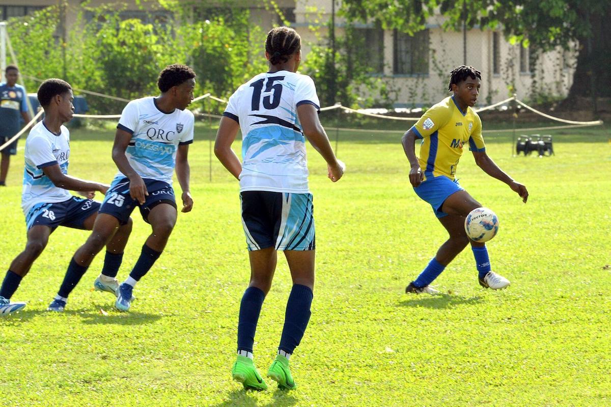 Presentation College attacker Roshaun Doobay, right, gets past three of his former Queen’s Royal College team-mates, from left, Jasai Theophilus, Teshaun Franklyn and Philip Gray during a Secondary Schools Football League Premier Division match at QRC Ground, St Clair on Saturday, September 14th 2024. PHOTO BY Robert Taylor