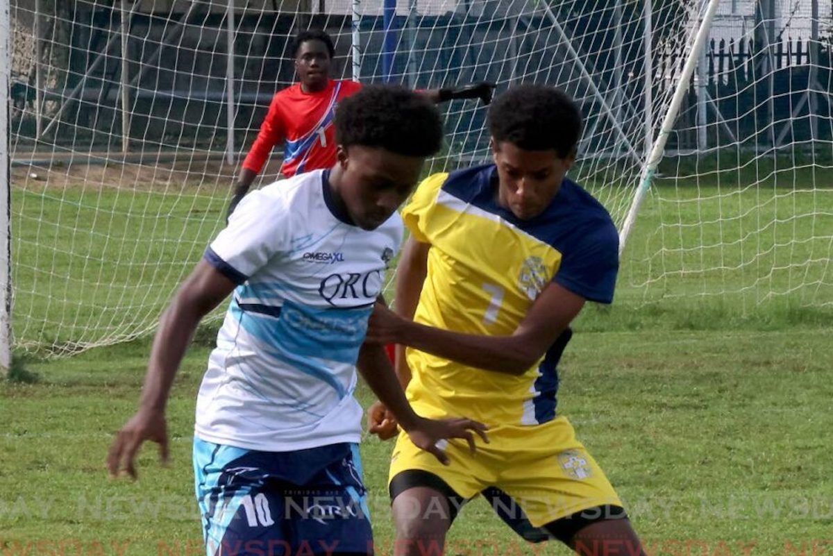 Queen’s Royal College’s Zion Aberdeen amd Trinity College East’s Deisean Plaza vie for control of the ball during their SSFL premiership division match, on October 19th 2024, at the Queen’s Royal College Grounds, Port of Spain. PHOTO BY Roger Jacob