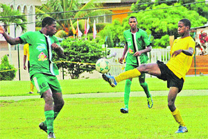 WATCHFUL: San Juan North Secondary's Josiah Trimingham, left, confronts this unidentified El Dorado West Secondary player (ball at feet) during their BGT&T/ First Citizens East Zone Secondary Schools Football League (SSFL) game yesterday. El Dorado won 1-0. –Photo: ANISTO ALVES