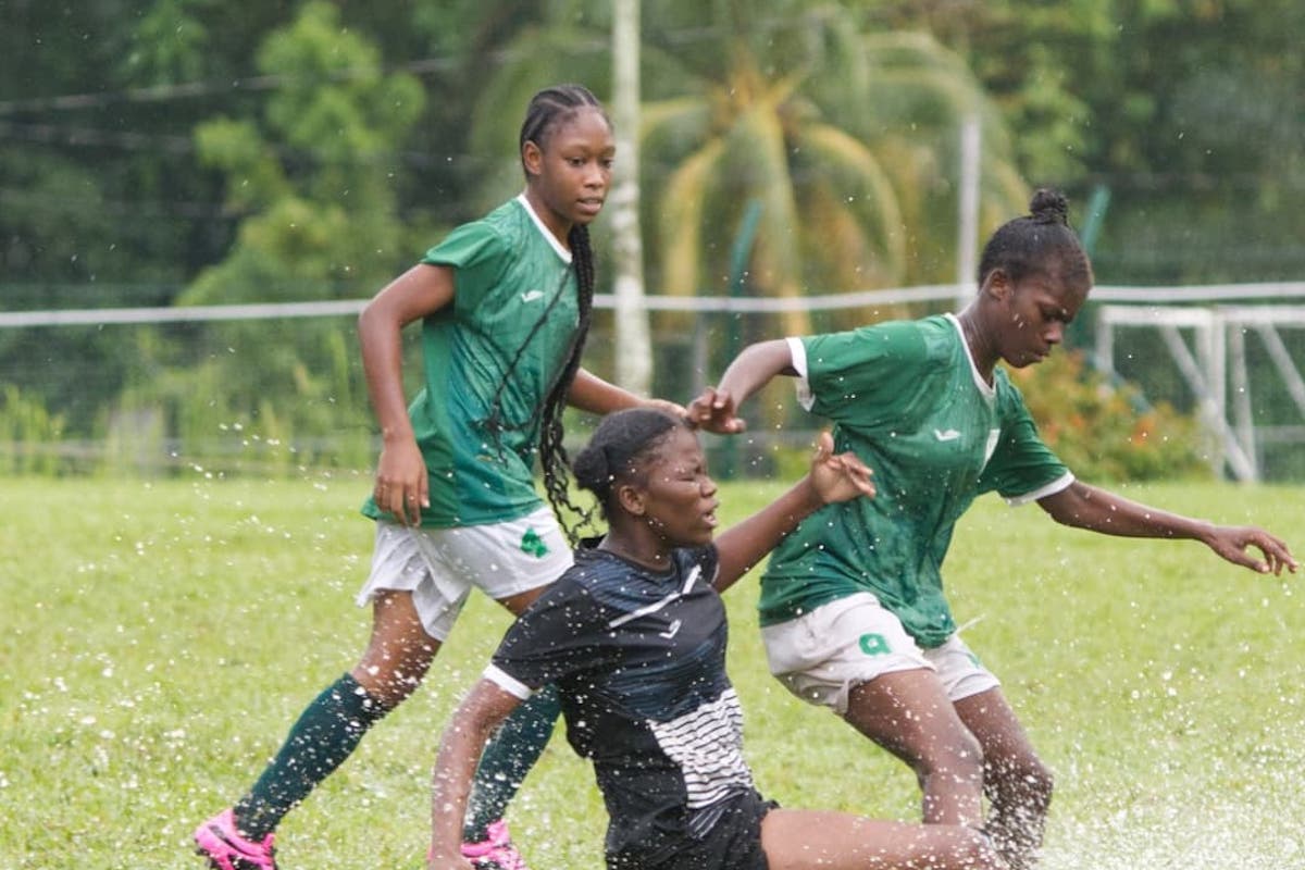 San Juan North Secondary's Shinika Lewis, right, tries to ride a tackle from a St Augustine Secondary player during Coca-Cola girls' East zone intercol semifinal action at San Juan North Secondary Ground on Monday, November 18th 2024. PHOTO BY Brian Miller