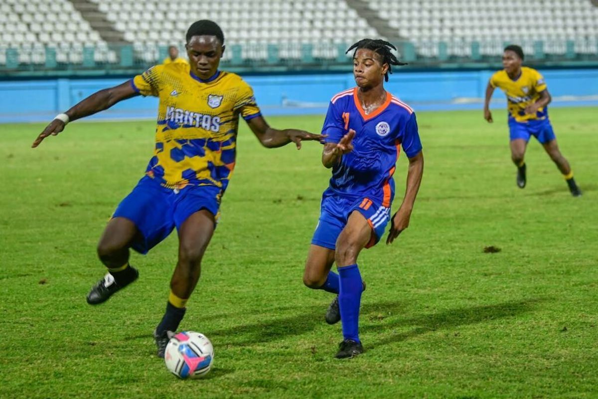 A Speyside High player, left, is marked by a Scarborough Secondary rival in the SSFL Tobago Intercol semis on Tuesday, November 12th, 2024 at Dwight Yorke Stadium, Bacolet, Tobago. PHOTO BY Visual Styles