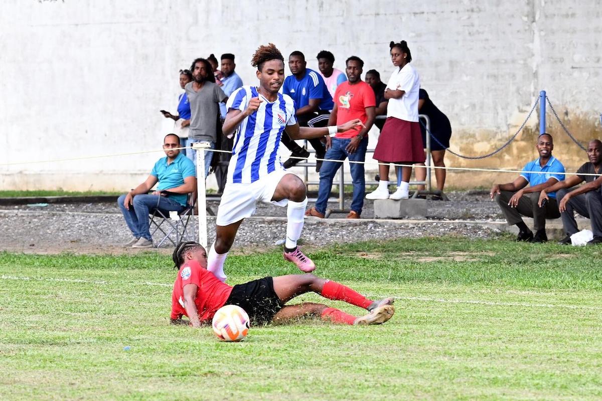 St Mary’s College player Elijah Wong, evades a sliding tackle from St Anthony’s College’s Aadil Jr Abdul-Hakeem, during their NGC SSFL Premiership Division match at St Mary’s College Ground, St Clair on Wednesday, September 11th 2024. PHOTO BY Ishmael Salandy