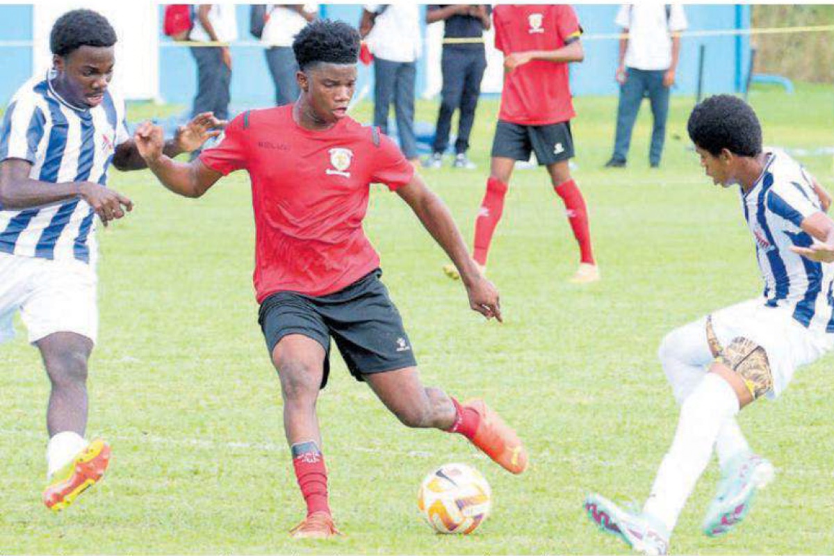 Mordecai Ford (C) of St Anthony’s College splits the St Mary’s College defence with this pass in their SSFL premiership division match at St Mary’s College Grounds, St James on Wednesday, September 11th 2024. PHOTO BY Angelo Marcelle