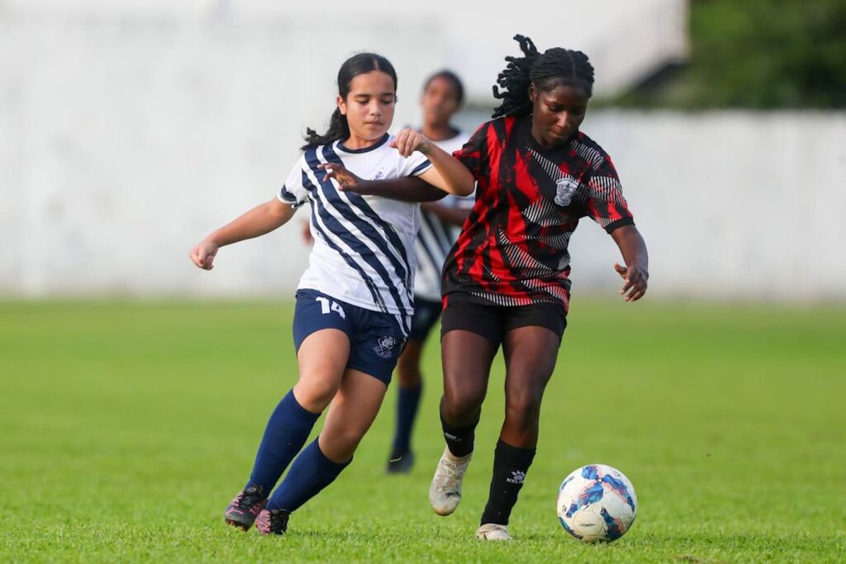 St Joseph Convent Port of Spain's Anushka Persad (L) tries to get the better of Bishop Anstey High's D’nae Bradshaw during the SSFL Coca-Cola Intercol Girls' North Zone semifinal at the St Mary’s College ground on Tuesday, November 19th, 2024 in Port of Spain. PHOTO BY Daniel Prentice