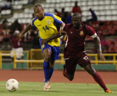 Photo: Defence Force captain Cory Rivers (left) ensured that North East Stars striker Cornell Glen did not have it his own way in the Toyota Classic finals. ...(Courtesy Photos868)