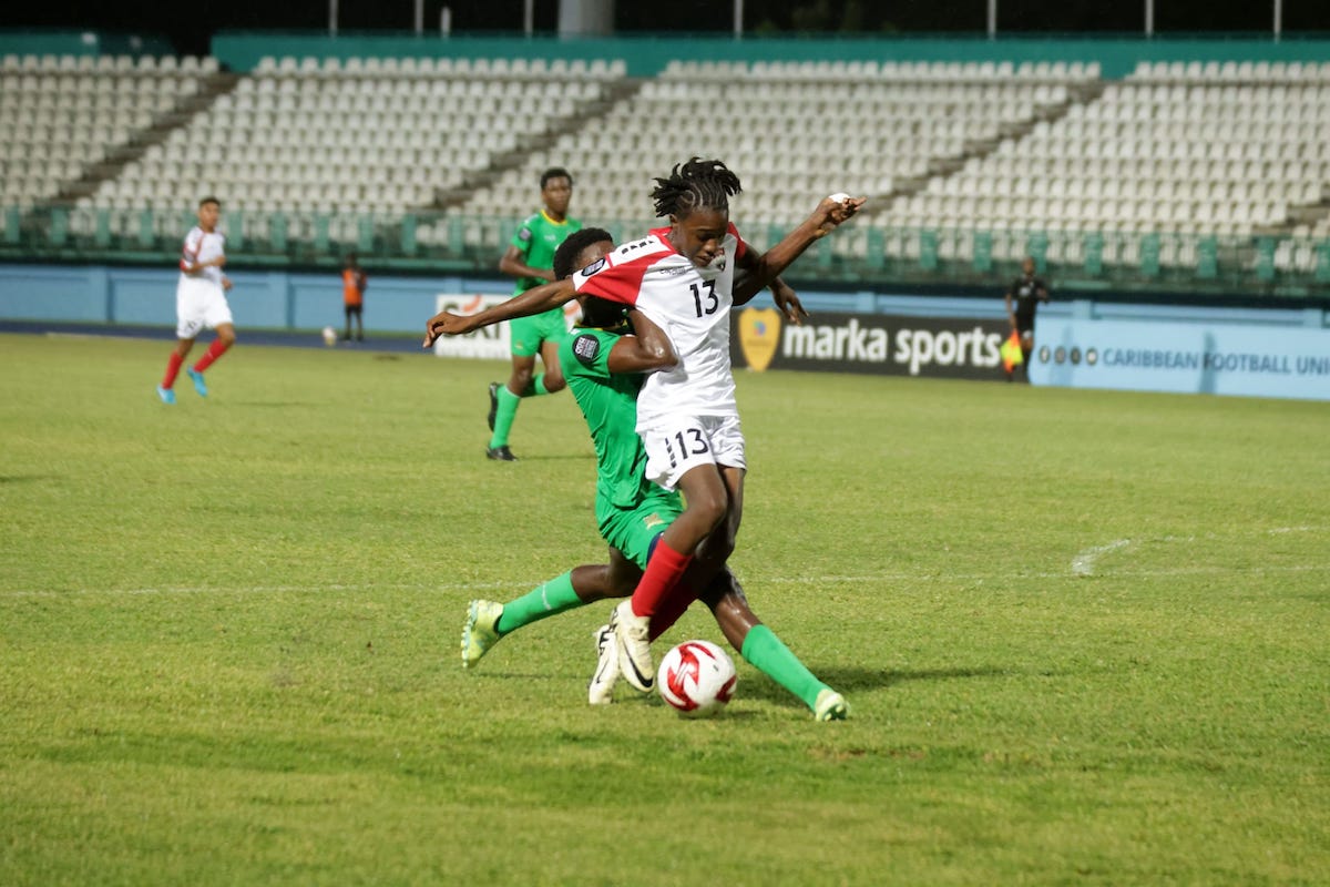 Trinidad and Tobago forward Jaeden Anthony tries to escape the attentions of a St Kitts and Nevis defender during CFU U-14 Series action at the Dwight Yorke Stadium, Bacolet, Tobago on Sunday, August 18th 2024.