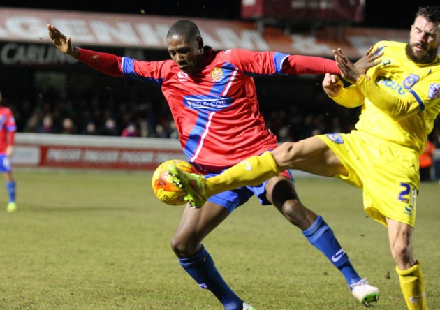 Daniel Carr of Dagenham & Redbridge battles with James Dunne of Portsmouth (pic: Dave Simpson/TGSPHOTO).