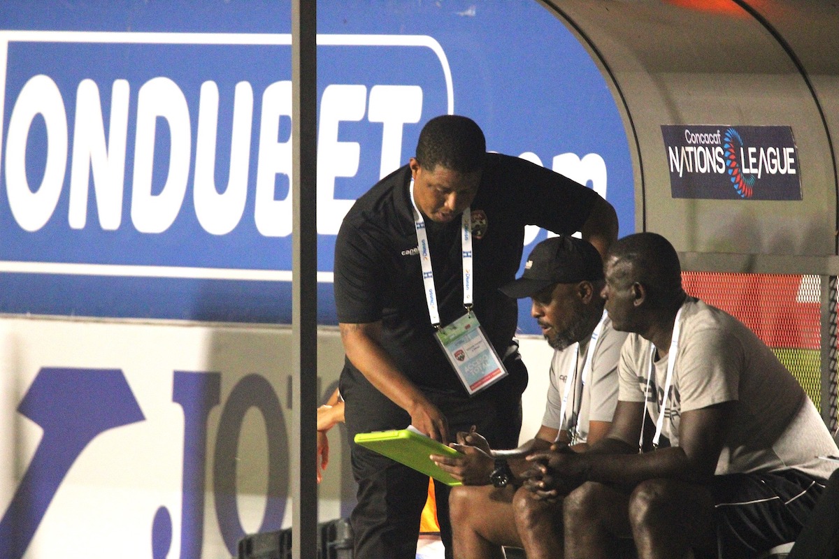 Trinidad and Tobago Interim Coach Derek King (left) reviews tactics with his technical staff during a Concacaf Nations League match against Honduras at Estadio Nacional Chelato Uclés, Tegucigalpa, Honduras on Friday, September 6th 2024.