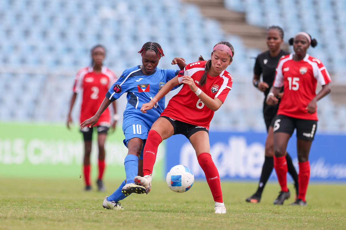 Trinidad and Tobago's Mia Lee Chong (#6) challenges Antigua and Barbuda's Latoya Williams (#10) for the ball during a Concacaf Under-15 Girls Championships match at the Hasely Crawford Stadium, Mucurapo on Monday, August 5th 2024.