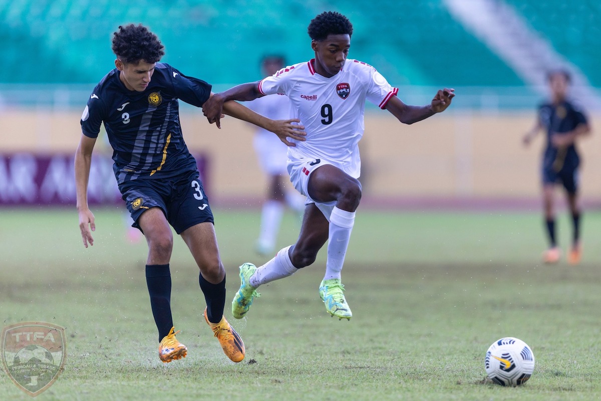 Trinidad and Tobago's Jonathan Mason (right) skips past Puerto Rico's Xzavier Colon (left) during a Concacaf Boys' U-15  Championship match at Felix Sanchez Stadium, Santo Domingo, Dominican Republic on Tuesday, August 8th 2023.