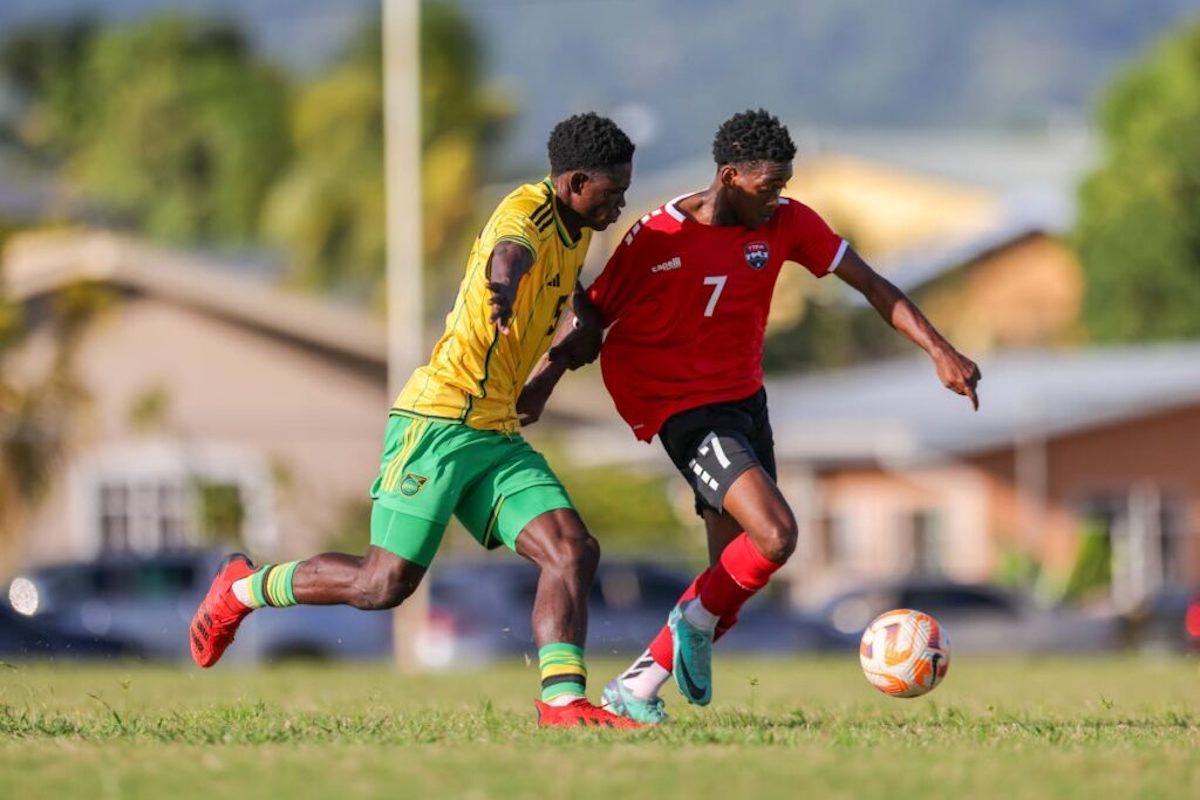 Trinidad and Tobago’s J'lon Matthews (R) is put under pressure from Jamaica’s Rolando Barrett during an international U-20 practice match at the Larry Gomes Stadium on Thursday, February 1st 2024 in Malabar. PHOTO BY: Daniel Prentice