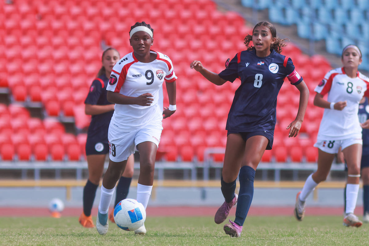 Trinidad and Tobago U-15 Girls' captain Shakila Hamilton (left) looks on as Dominican Republic captain Kaylee Lainez plays a pass during their League B semifinal in the Concacaf Girls' U-15 Championship at the Hasely Crawford Stadium, Mucurapo on Friday, August 9th 2024.