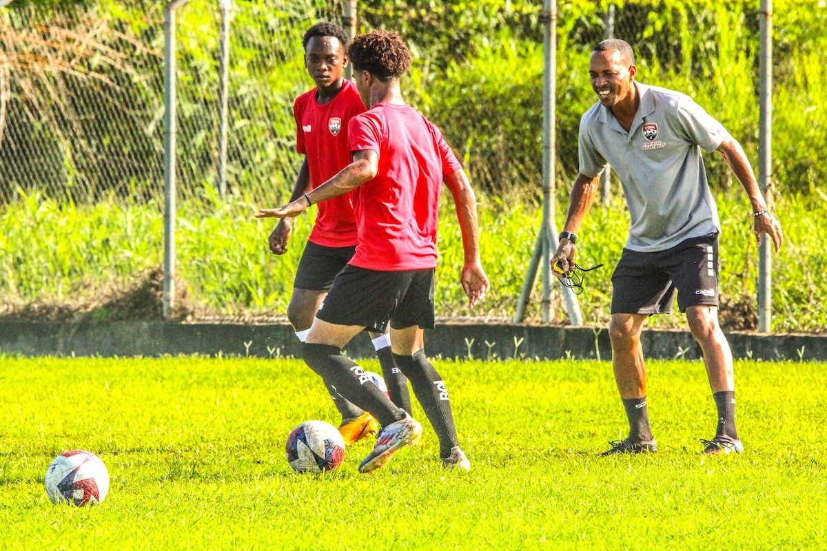 Trinidad and Tobago U-14 Head Coach Densill Theobald (right) looks on during a training session.